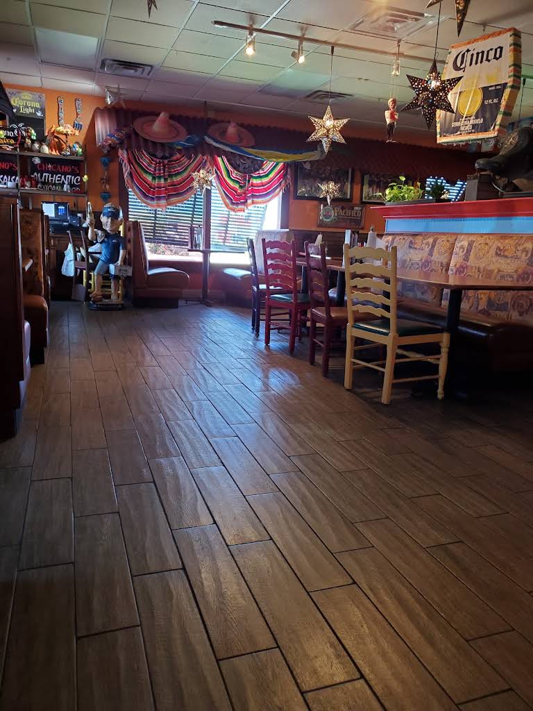 Dining room at Chicanos with colorful chairs, wall art and hanging stars